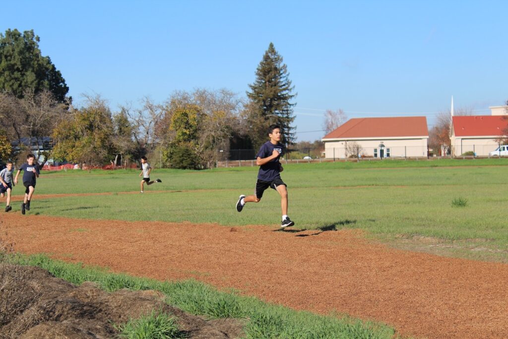 Students run during PE on the new 1-mile track.