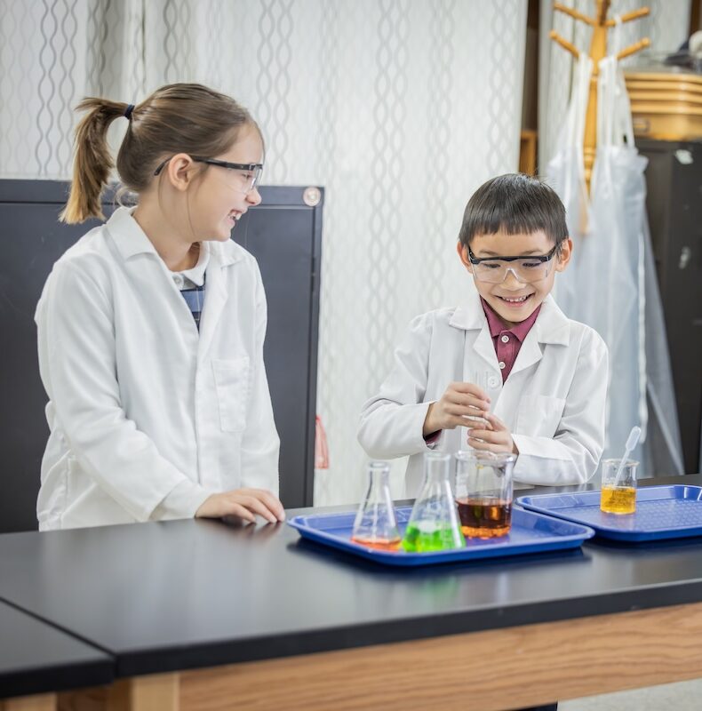 Second graders finish a beaker experiment in the Science Lab.