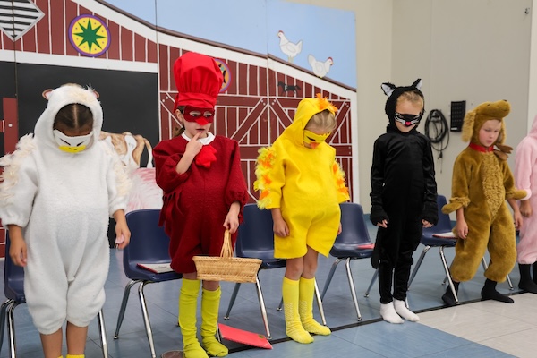 First graders perform a reader's theatre of The Little Red Hen.